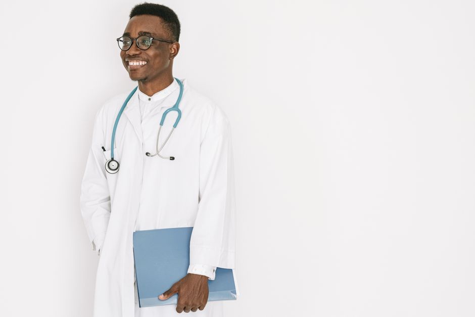 Confident doctor with stethoscope and folder, exuding professionalism and warmth.